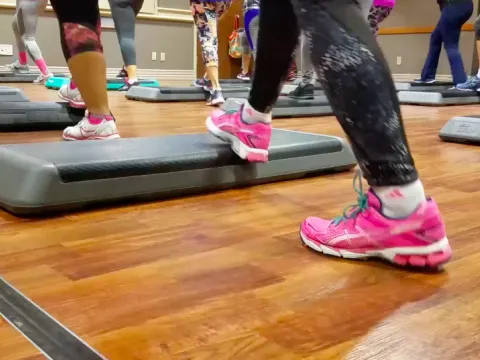 Community members take a free step aerobics class