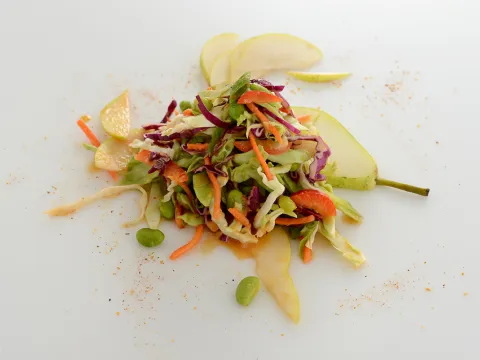 Mound of vegetable slaw on white surface