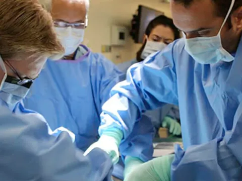 Surgeons operating on a patient.