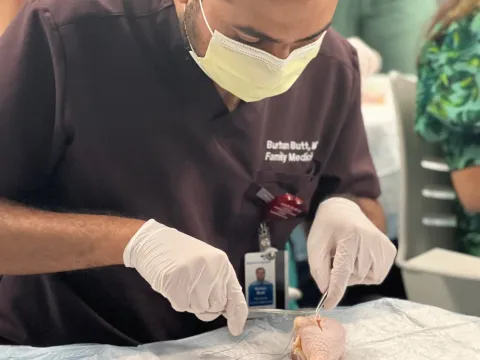 Family Medicine Residency team member practicing surgical exercise