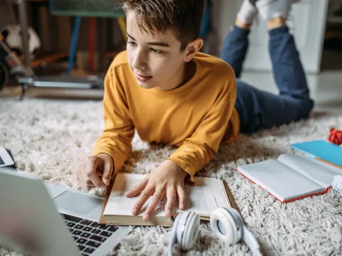 A teenage boy doing his homework.