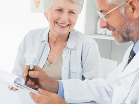 A senior talks with her doctor.