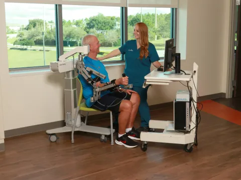 A Physical Therapist Helps a Patient During a Session.
