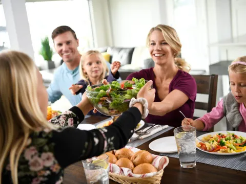 Family enjoys meal together at the dinner table