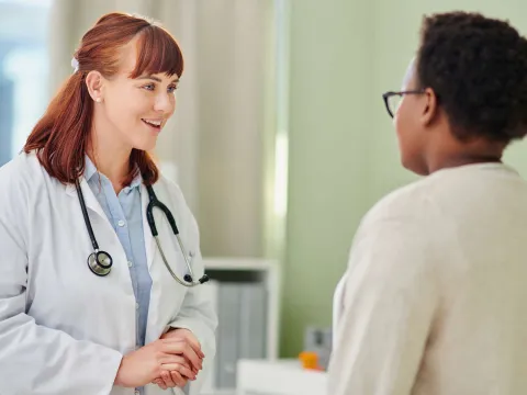 Female doctor talks with female patient