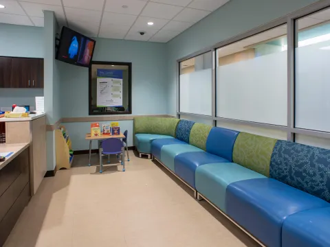 Waiting room with chairs and a desk.