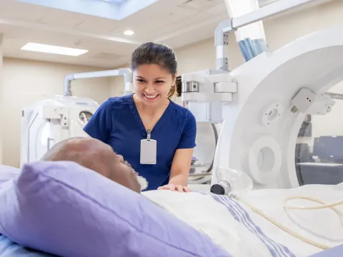 A nurse comforting a patient with her presence