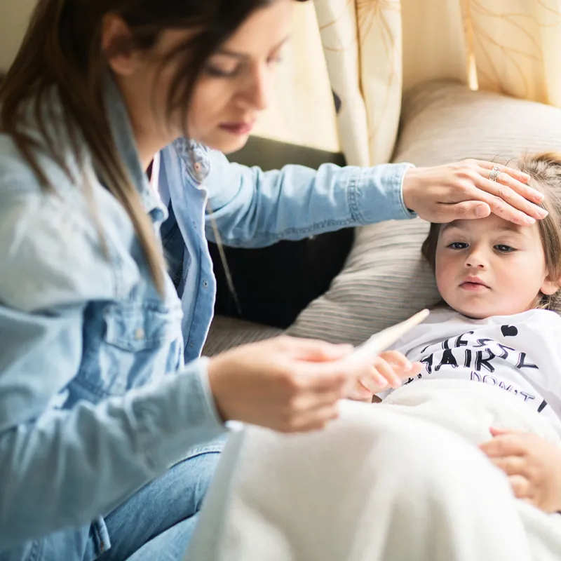 A mother checking her child's fever