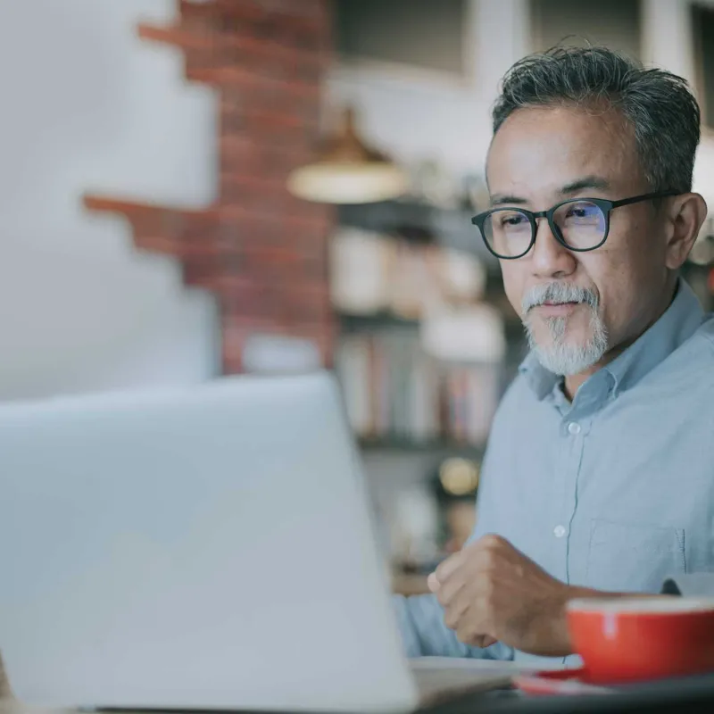 An mature man on his laptop