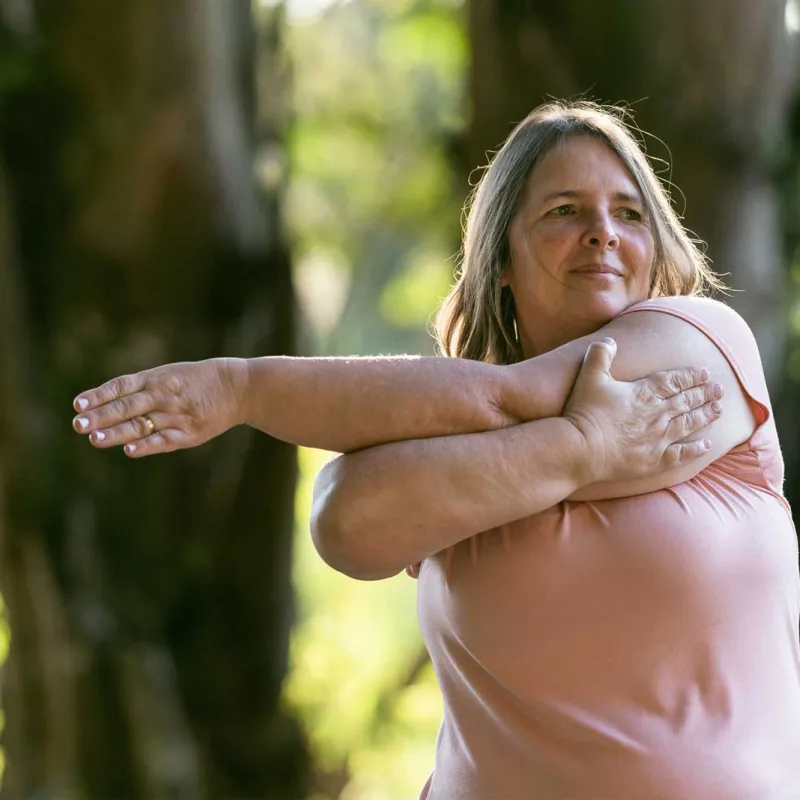 A woman stretching her arms outdoors