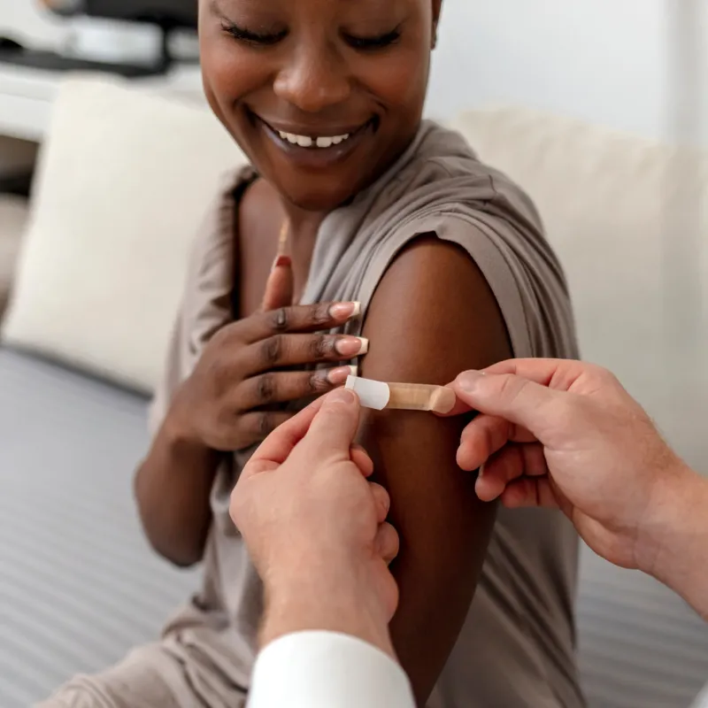 A Woman Smiles After Receiving Her Flu Shot