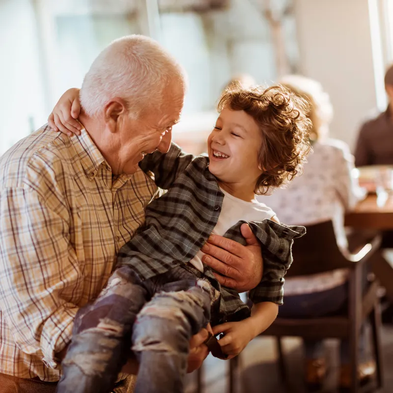 Grandfather playing with grandson.