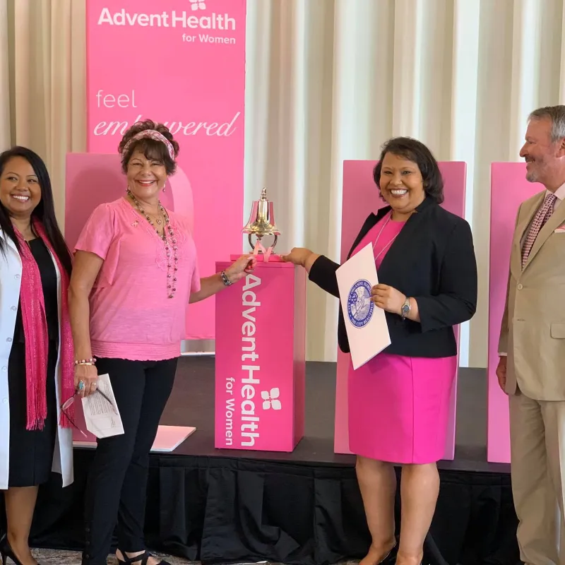 Breast cancer survivors ringing the Pink Out bell. 