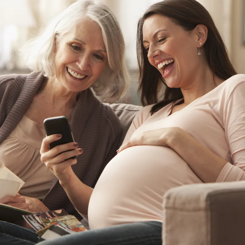 Pregnant woman looking at photos