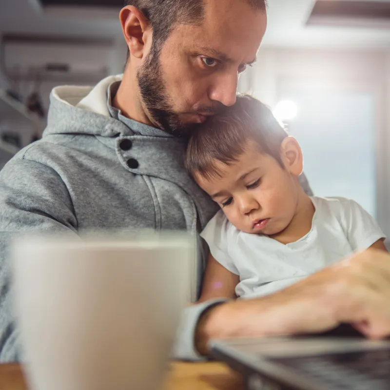 Father and son on the computer together.