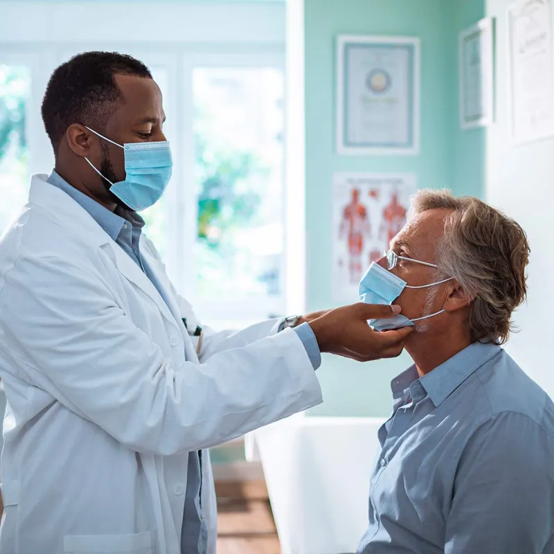 Man seeing doctor wearing PPE