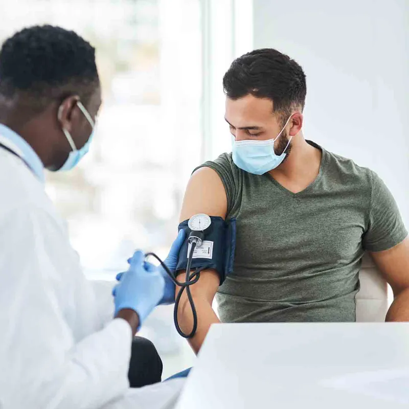 Male doctor wearing mask with male patient