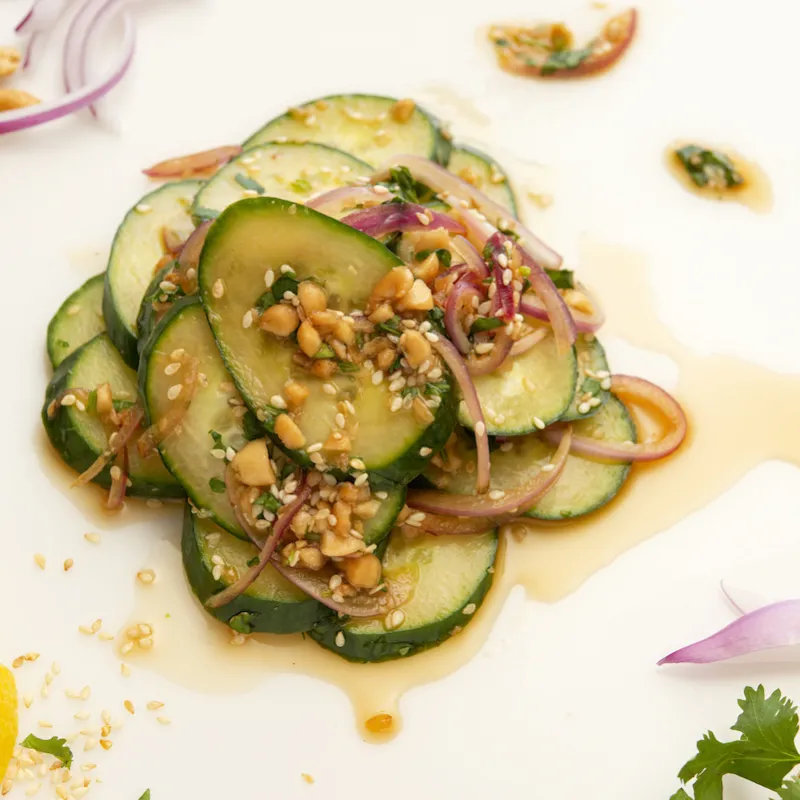 Mound of cucumber salad with lemon garnish