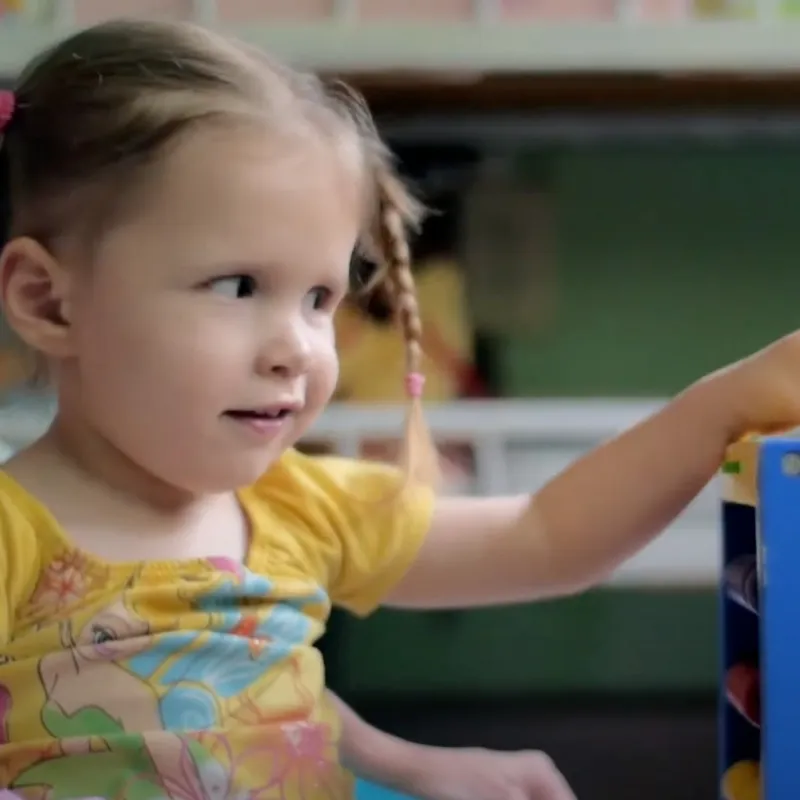 Joscelyn playing with her toys