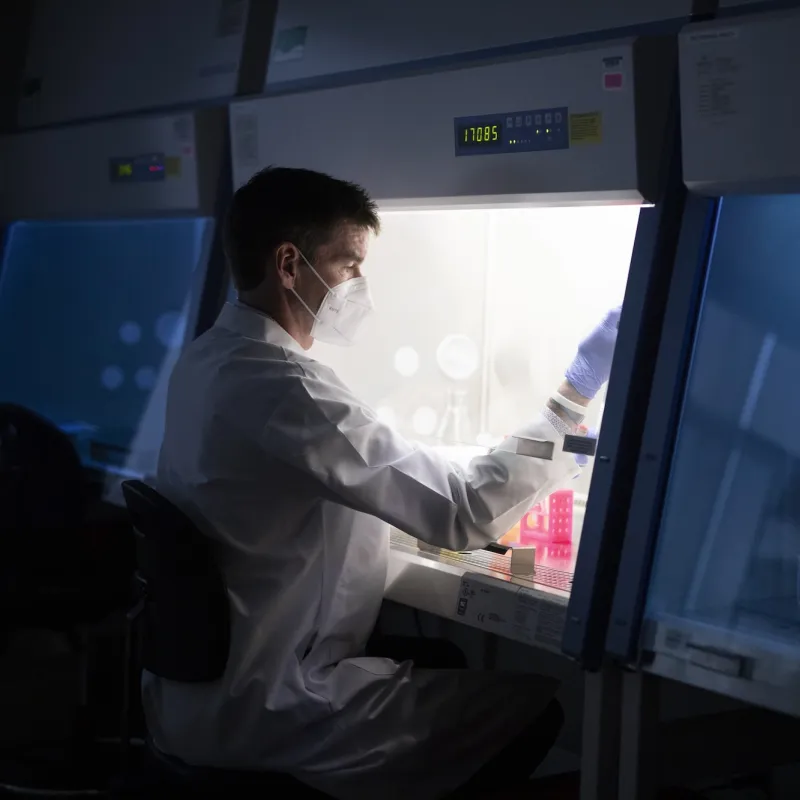 Masked Man doing scientific work in a lab