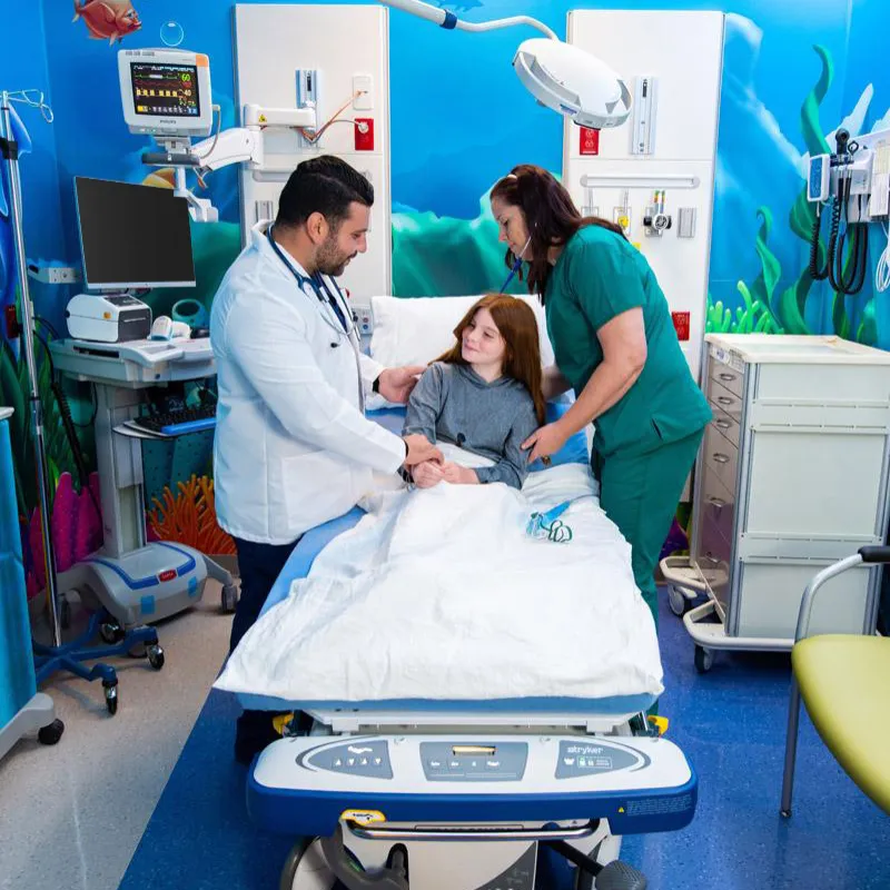 Doctor and nurse standing beside patient