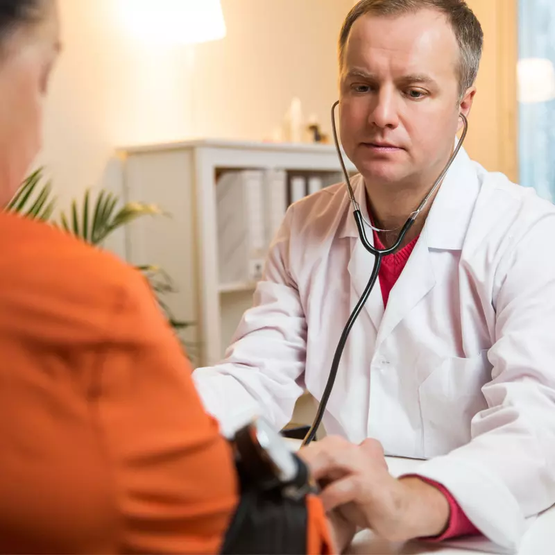 Doctor checking a patient's blood pressure.