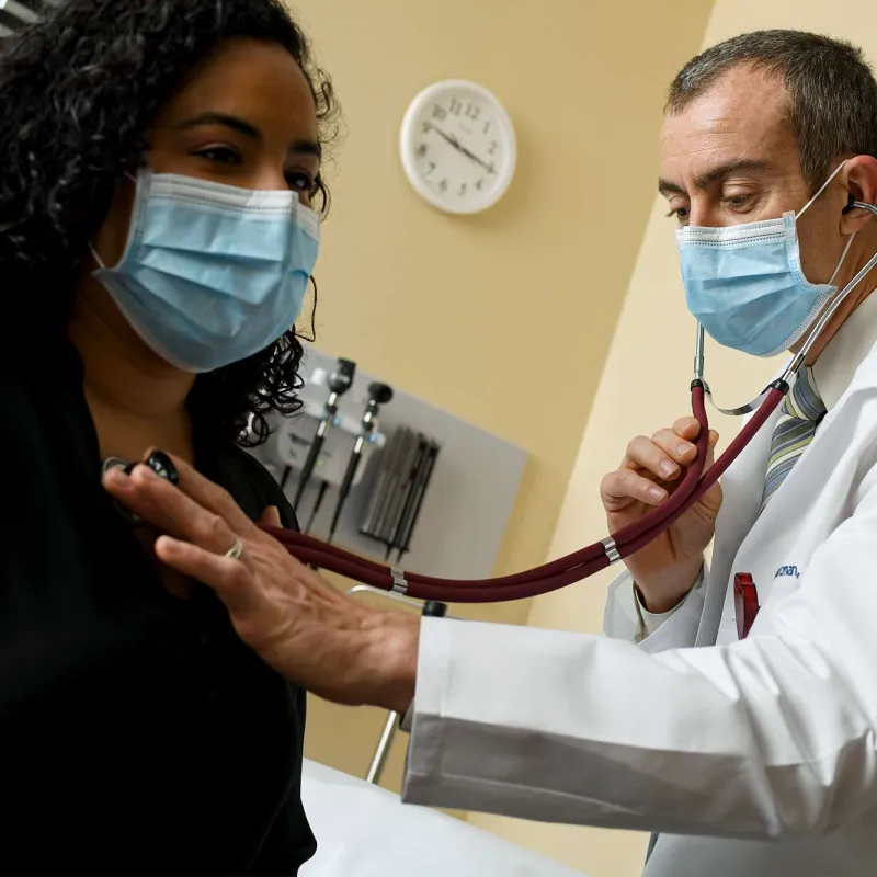 A doctor checking up on a patient. 