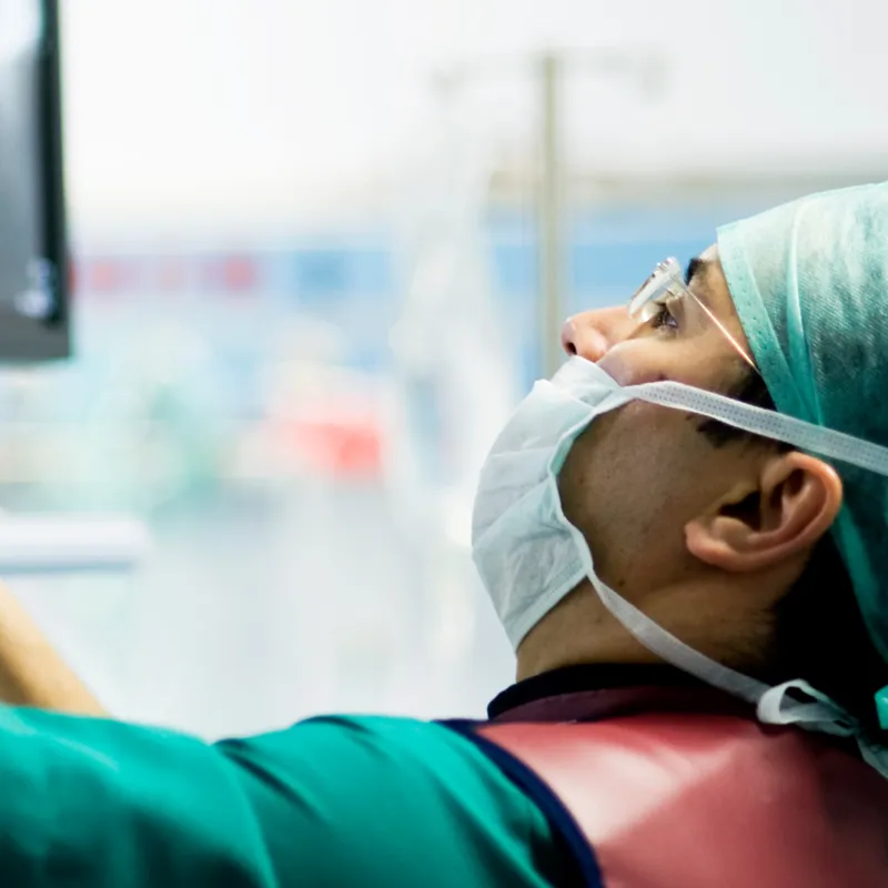 Doctor Looking at Monitor in Surgery.