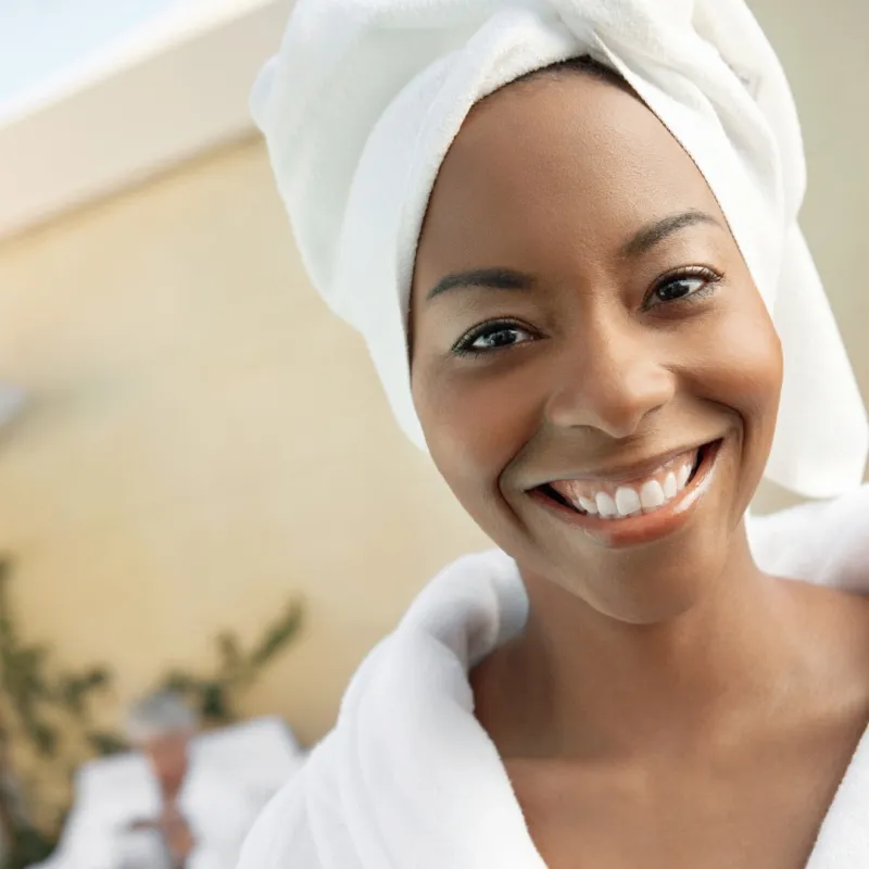 A smiling African-American woman at a spa