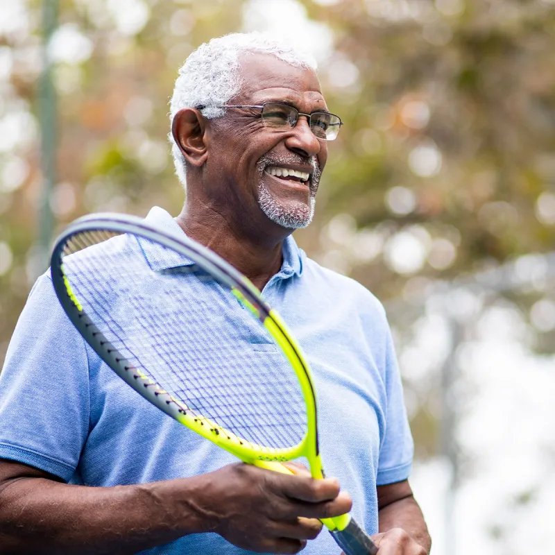 Man holding a tennis raquet  