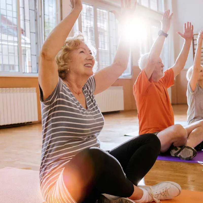 A group of seniors doing a yoga session