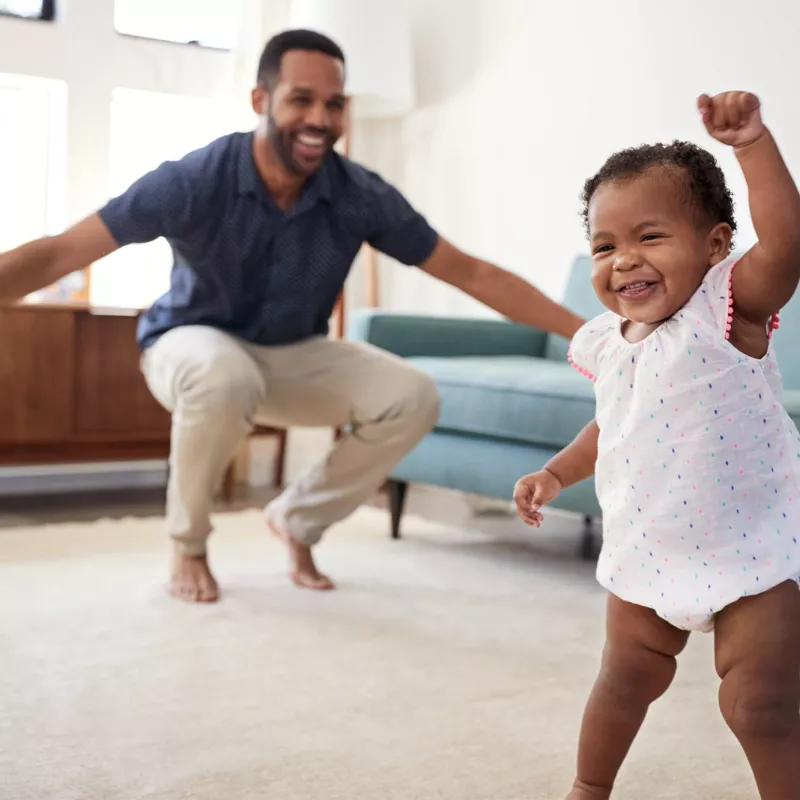 A father and baby playing at home. 