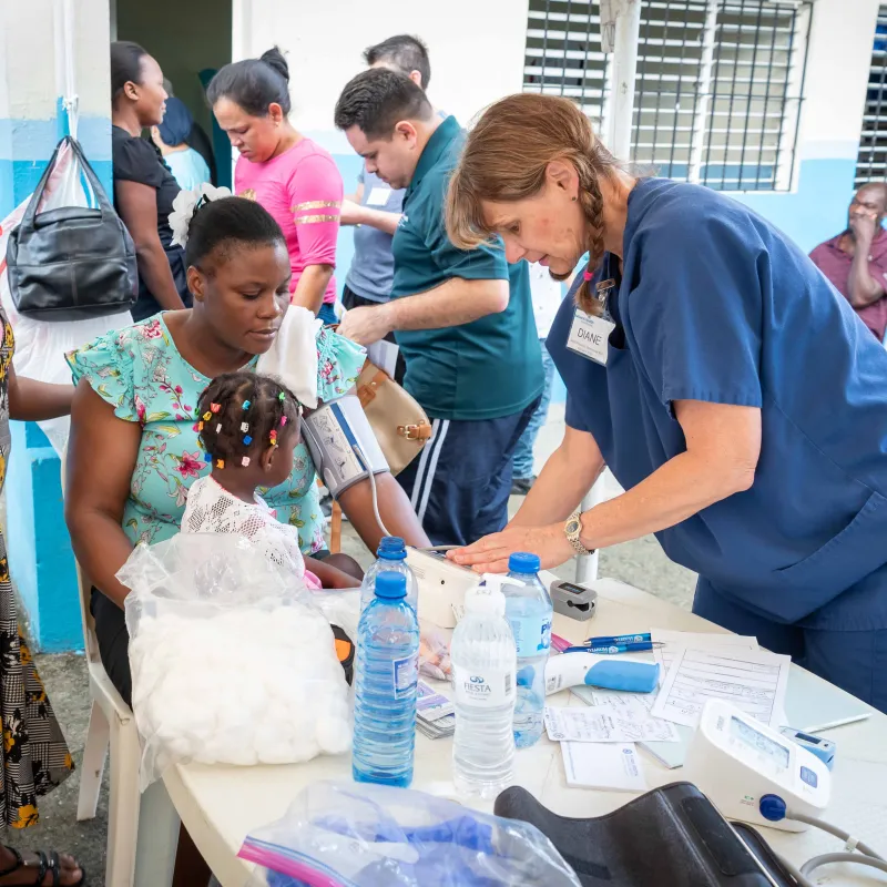 A nurse doing clinical work on a mother