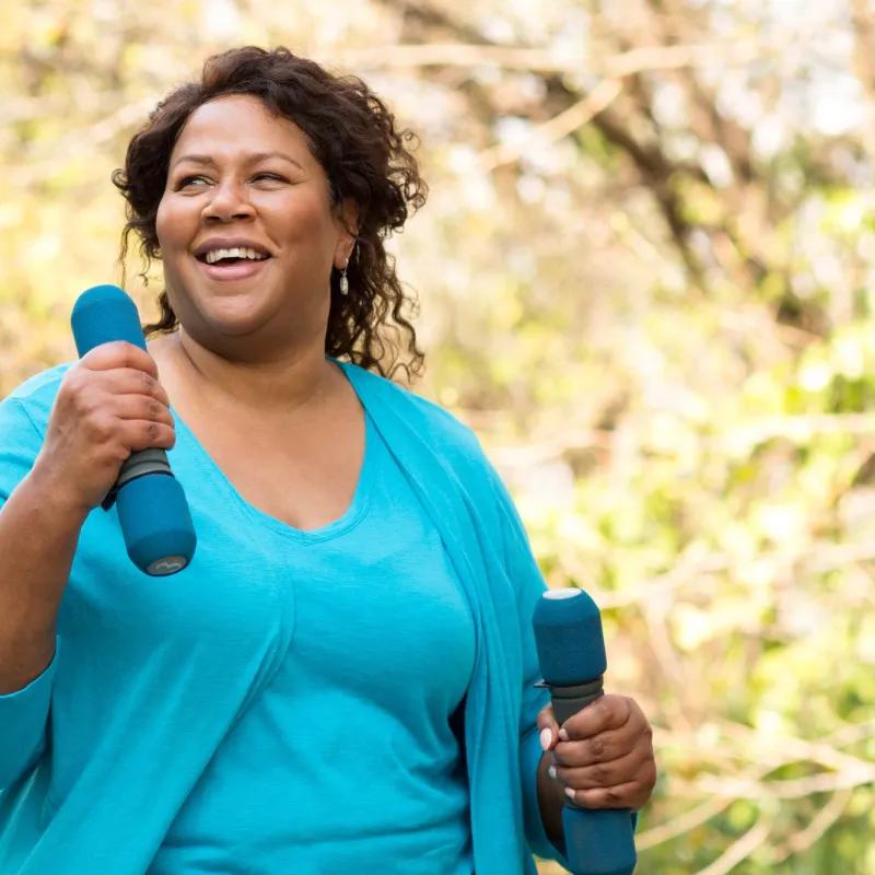 An overweight woman exercising outdoors