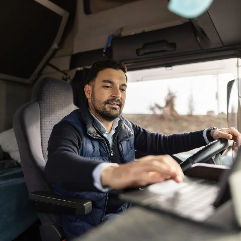 A Commercial Driver Check's the Laptop in His Truck