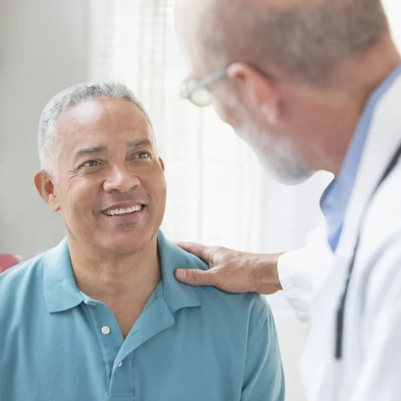 Blue Shirt Hispanic Man with Caucasian Doctor