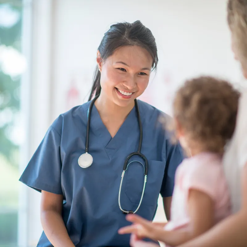 Nurse talking with mother and child.