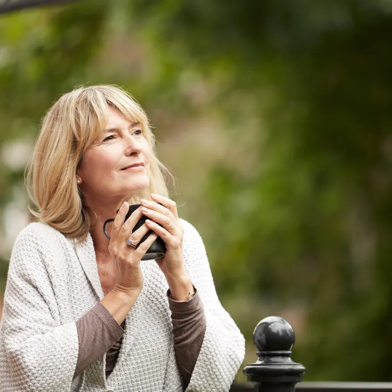 woman holding cup outdoors