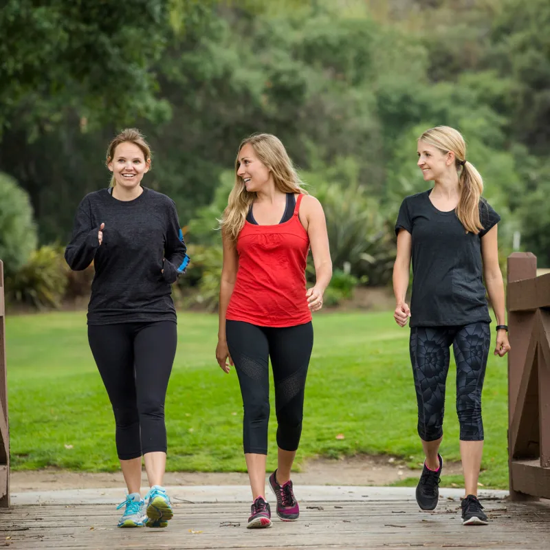 Three women in their 30s enjoy their morning walk.