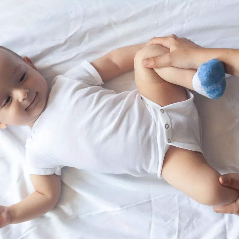 A baby laying on a bed