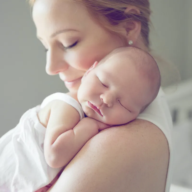 A new mom holds her infant.