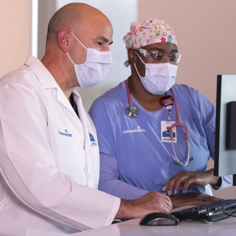 AdventHealth clinical staff working at a computer.