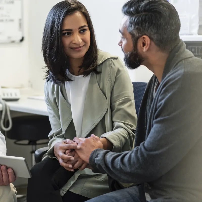 A couple discusses their care with their doctor.