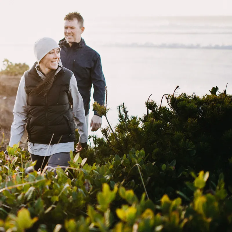 A couple hiking in a bushy area