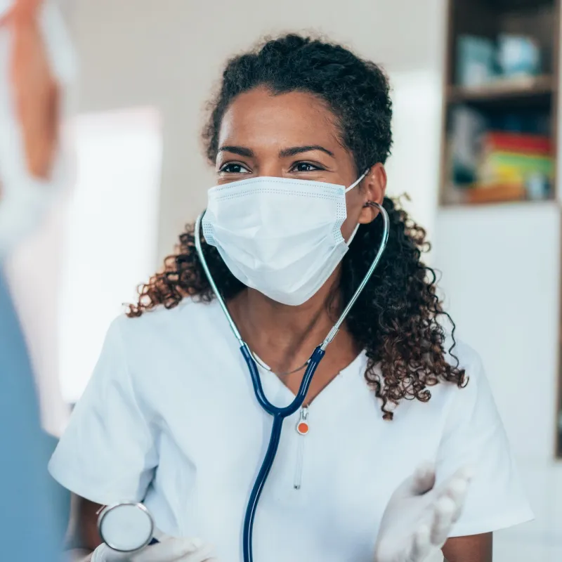 A doctor talking to a patient during an office visit.