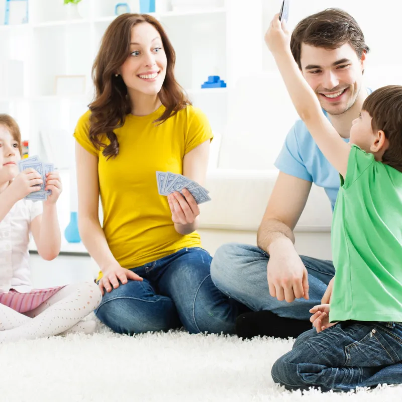 A family plays a game of cards together.