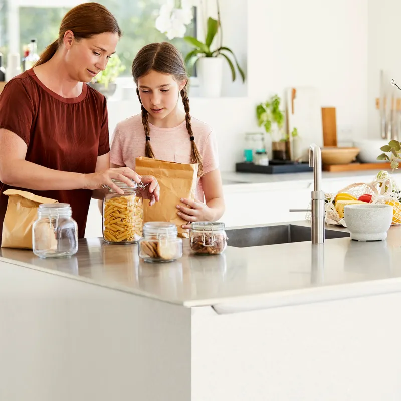 Mother and daughter preparing food.