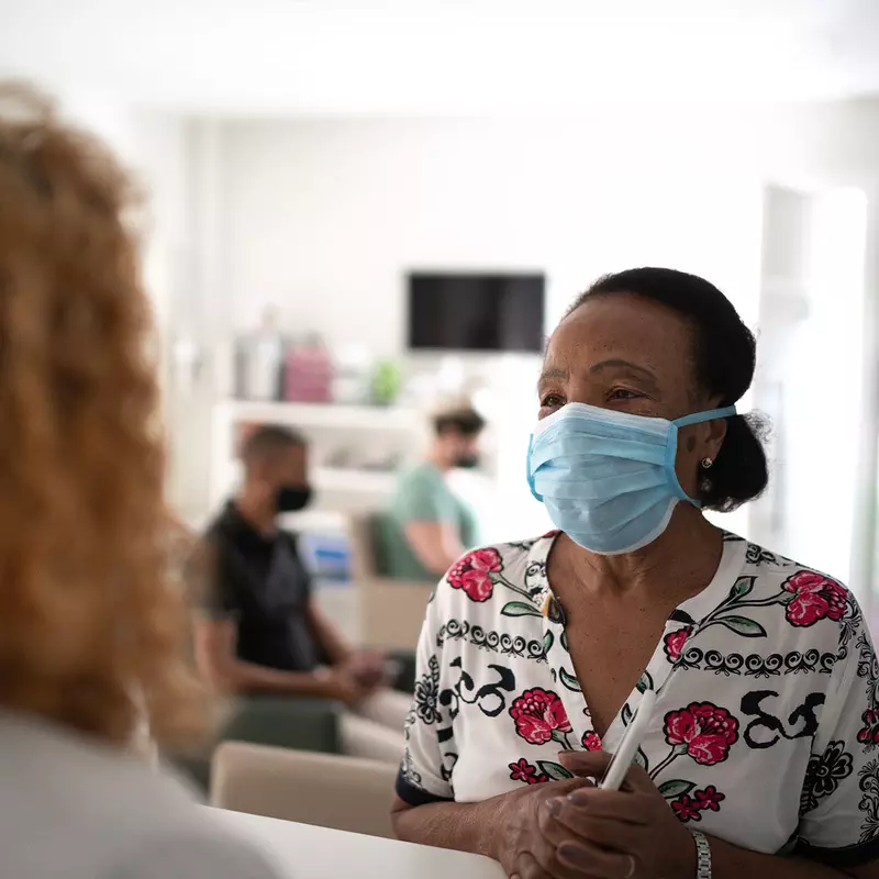 An elderly woman talking with her doctor