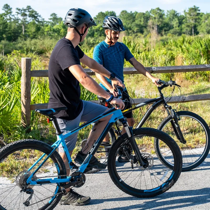 Two men standing beside their bikes