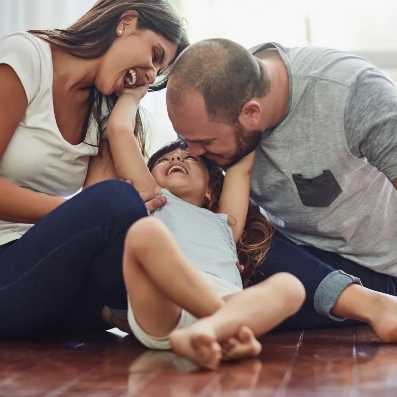 A gigging family plays with their toddler.